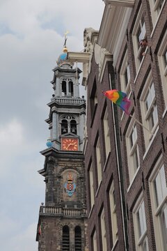 Amsterdam Westerkerk Church Tower With Historic House Facades And Rainbow Flag