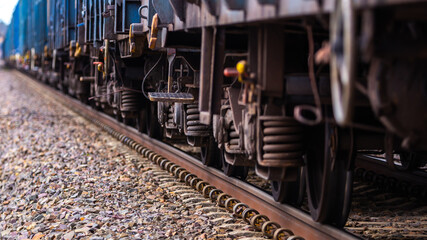 Trolleys and wheels of cargo train . Photo taken in low light conditions.