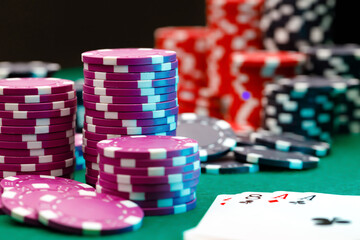 Playing cards and chips on green casino table background