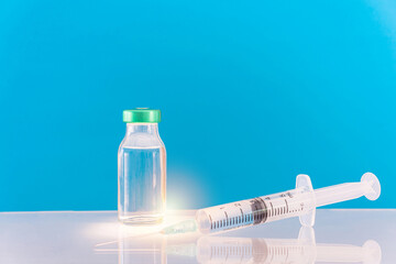 Potential trials stage concept on blue background. Close up Vials with sterile needle syringe. Research and Development, Vaccination.