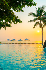 Umbrella and chair around swimming pool with sea ocean view