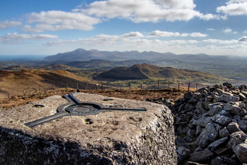 Trigonometrical point on Slieve Croob peak. Lanscape view of the Mourne Mountains on the background, Co. Down, Northern Ireland.