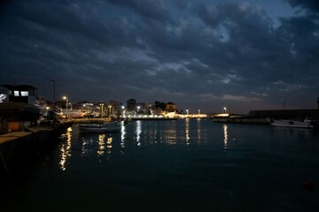 Batroun harbor in Lebanon at night with dramatic cloud sky