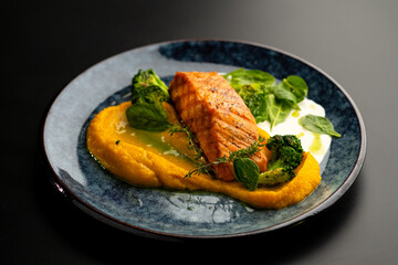 Grilled red fish fillets. Salmon with vegetable puree and spinach.