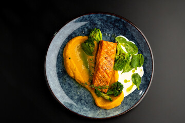 Grilled red fish fillets. Salmon with vegetable puree and spinach.