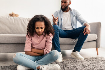 Family Conflict. Angry black father scolding sad daughter - obrazy, fototapety, plakaty