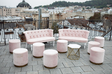 Beautiful interior of luxury hotel. Concept of expensive relaxation and relaxation in roof. Pink velvet restaurant sofas