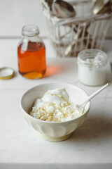 Cottage cheese with sour cream in a bowl for healthy breakfast