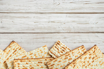 Concept of Jewish holiday Pesach. Passover. Traditional matzah on a white wooden background. Matzo bread.
