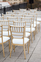 Fototapeta na wymiar Many white chairs are lined up for guests on the roof of the house to celebrate