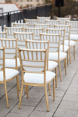 Many white chairs are lined up for guests on the roof of the house to celebrate