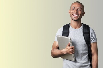 Smiling young college student with laptop