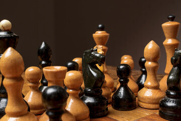 Old wooden chess standing group on the board, as if plotting something. 