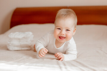 baby boy lies on his stomach on the bed in the bedroom