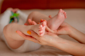 Obraz na płótnie Canvas Baby feet in parent hands. Maternity, Happy Family concept.