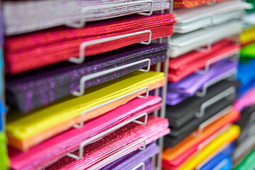 Sheets colored cardboard for designer creative works. Stacks multicolored drawing paper in the store. Colorful art papers on shelf for sale stationery store
