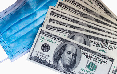 One hundred american dollars close up and medical mask. Coronavirus symbol