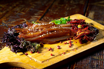 Dried meat on a wooden board.