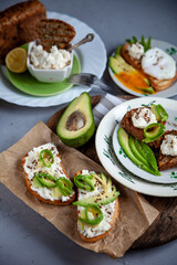 Sandwiches with soft cheese, avocado and cucumber. Breakfast is on the table. Healthy food. Toast...