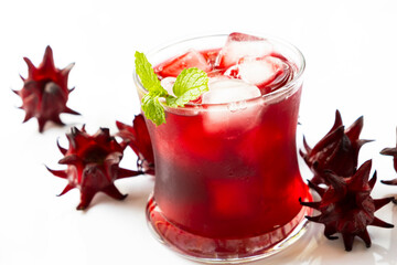 Roselle juice with hibiscus flower on white background.