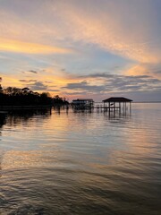 colorful sunset with reflections over bay water