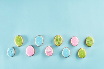 Painted gingerbread eggs over light blue background