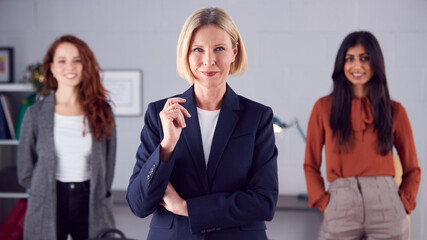 Fototapeta na wymiar Portrait Of Female Multi-Racial Business Team Standing In Office