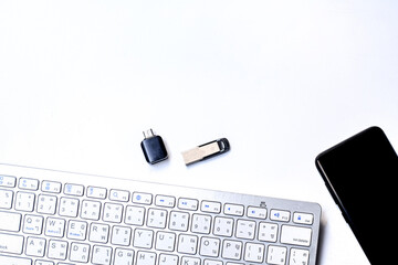 keyboard and a phone with storage on a white background