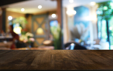 Empty wooden table in front of abstract blurred background of coffee shop . can be used for display or montage your products.Mock up for display of product