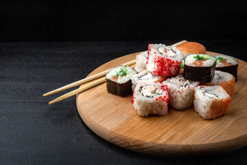 Sushi rolls on black background. Japanese food.
