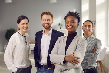 Business center employees. Portrait of a positive young multiracial team posing in the office...