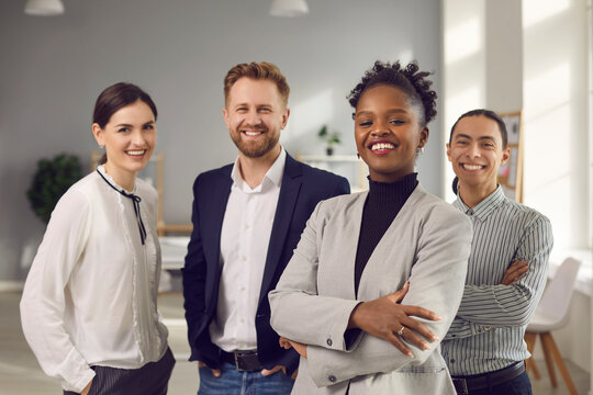 Business Center Employees. Portrait Of A Positive Young Multiracial Team Posing In The Office Looking At The Camera. Concept Of International Relations And Business.