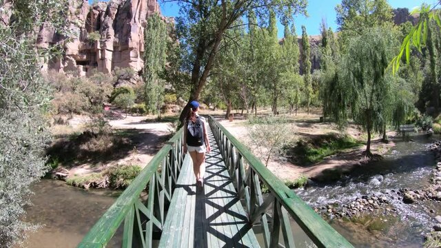 Female tourist walking on the bridge inIhlara valley in Cappadocia, Turkey