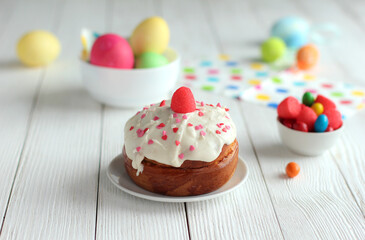Spring and еaster holiday concept 
close up of an easter cake with colored eggs on white table

