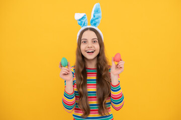 happy easter child girl in rabbit bunny ears showing painted eggs for holiday, happy easter