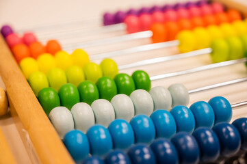 Bright colored hand abacus. Children's wooden toy for the study of arithmetic.