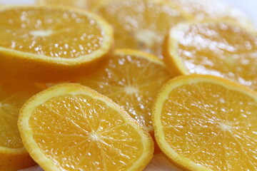 Fototapeta na wymiar slices of juicy yellow orange on a plate