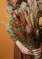 Bright trendy composition of dried flowers, home decor, a long-lasting gift of flowers and herbs