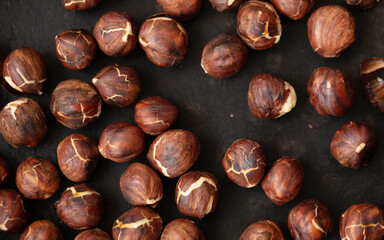 Roasted dried hazelnuts on iron pan.