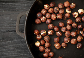 Roasted dried hazelnuts on iron pan.
