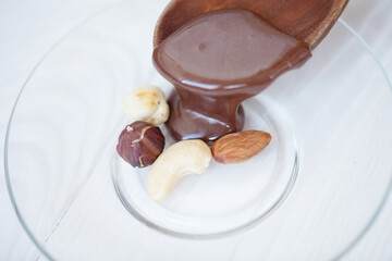 Hot melted chocolate pouring on the nut.