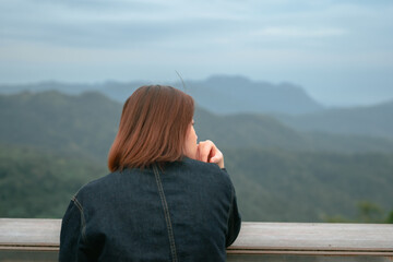 solo asian woman hipster traveler taking photo to mountain at outdoor bar of coffeeshop