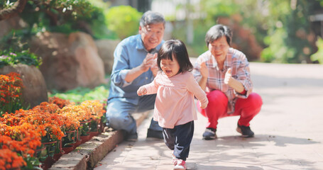 couple play with granddaughter