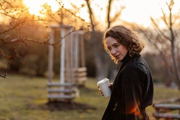Beautiful young Caucasian woman enjoy sunny spring day, park cherry garden, romantic portrait,...