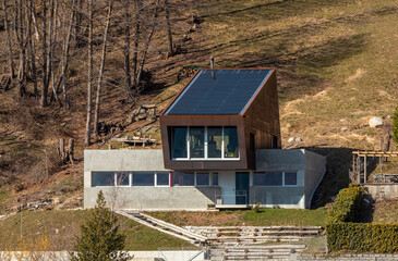 Fototapeta na wymiar Exterior modern isolated villa, surrounded by nature. Iron and concrete cladding