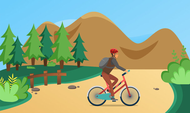 Man rides bicycle on sandy road in forest. Sportsman cycling on background of mountain landscape