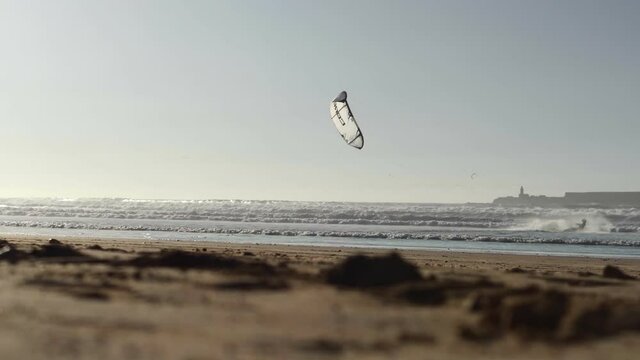 Kiteboarding activity in the waters of Morocco, Essaouira. Kiteboard, surfer, sea, ocean, waves, board, extreme sport, sportsman, summer, vacation / 4K Video Footage