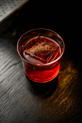 Close-up view of glass with drink and ice cube on bar counter