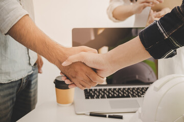 Close up hand of group, team young contractor, engineer handshake with partnership, customer after agreement to work together at the site, workplace, office. Business success concept.