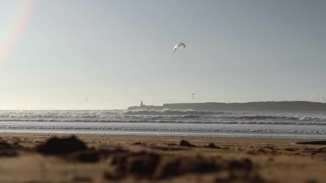 Kiteboarding activity in the waters of Morocco, Essaouira. Kiteboard, surfer, sea, ocean, waves, board, extreme sport, sportsman, summer, vacation / 4K Video Footage